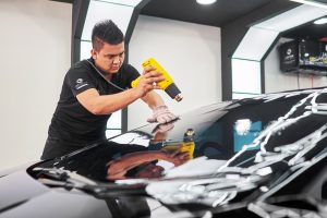 Lavish Window Film's staff is applying window tint to a car.